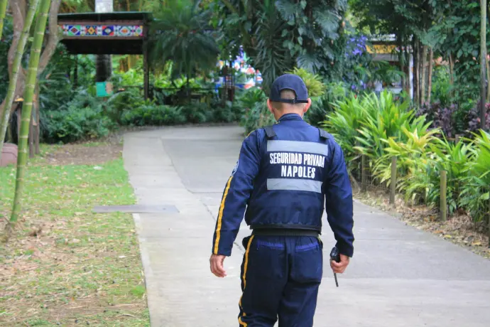 a police officer is walking down a sidewalk